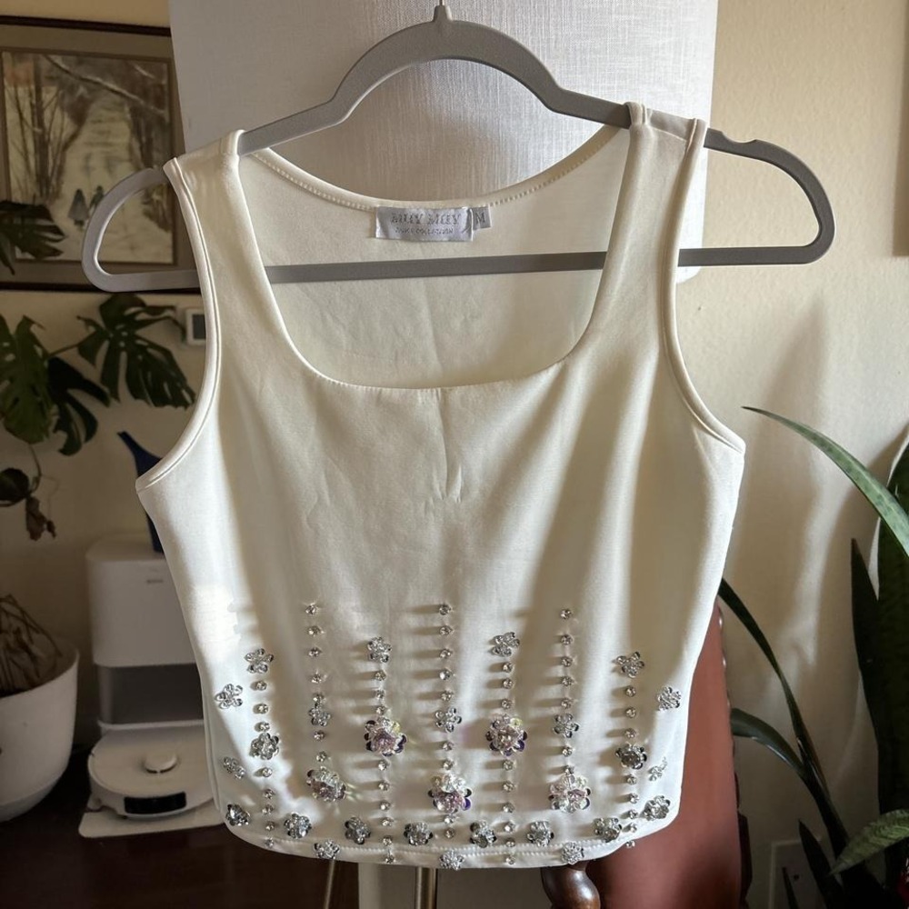 Cream, cotton spandex shirt rhinestone and flower decals on the bottom